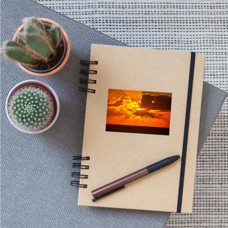 brilliant shining sun behind clouds rises