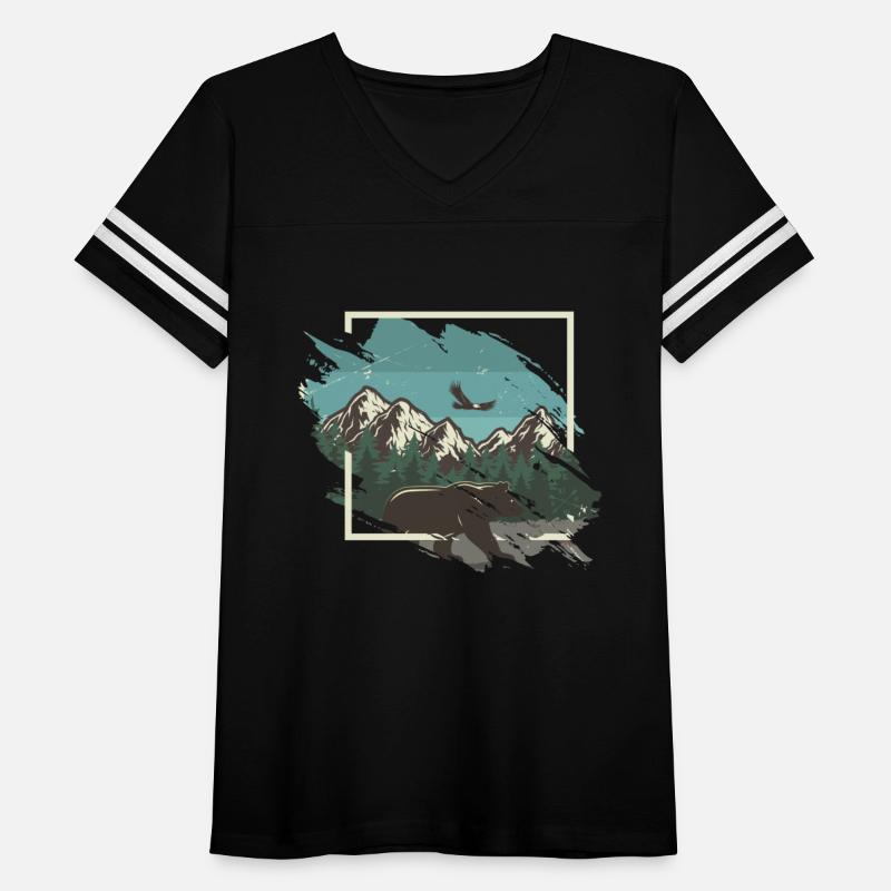 Bear in front of a snowy mountain panorama