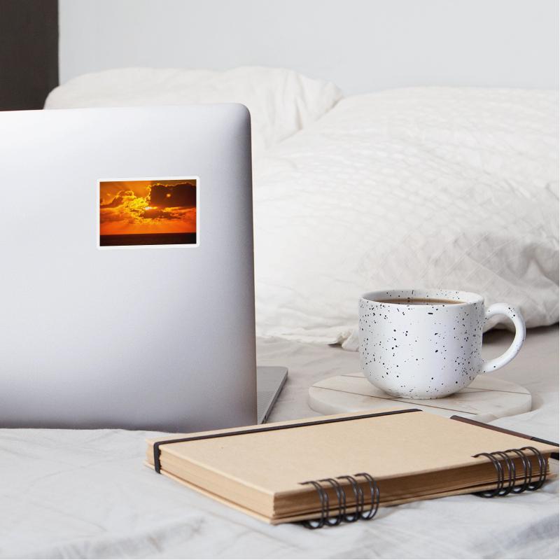 brilliant shining sun behind clouds rises